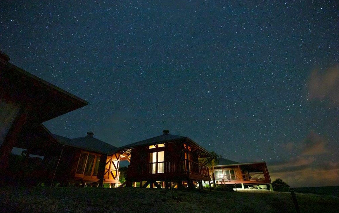 several small cabins under a starry sky